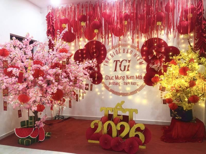 Dịch vụ trang trí Tết với tiểu cảnh Tết trọn gói gồm hoa đào, hoa mai và trang trí đèn lồng đỏ nổi bật.